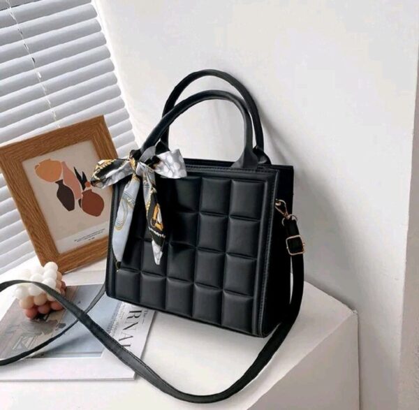 drafted  black  leather  hand bag